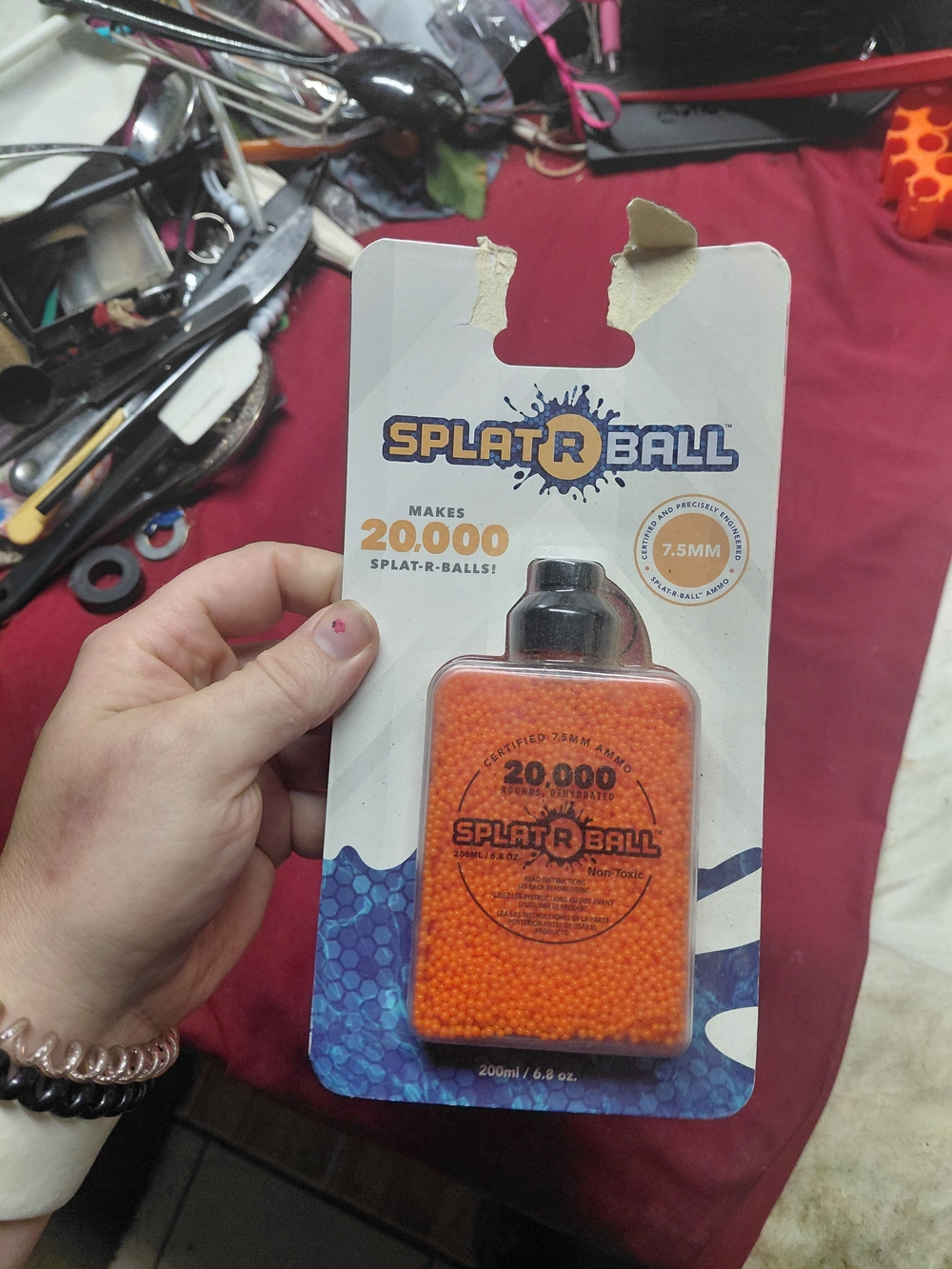 SplatRBall 20,000 round bottle of 7.5mm orange water gel ammunition.